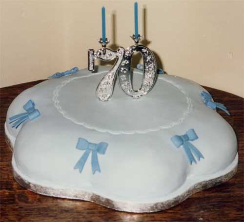 A rich petal-shape 70th birthday fruit cake with a simple design.